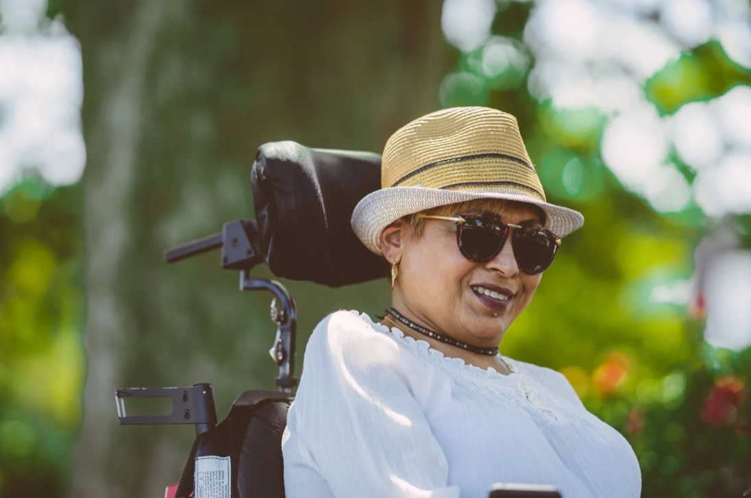 Woman in wheelchair enjoying outdoors, representing NDIS participant independence